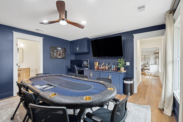 recreation room with ceiling fan and light wood-type flooring