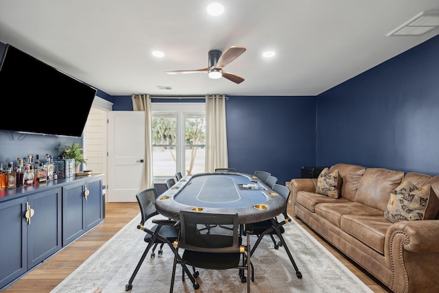 recreation room with ceiling fan and light hardwood / wood-style floors