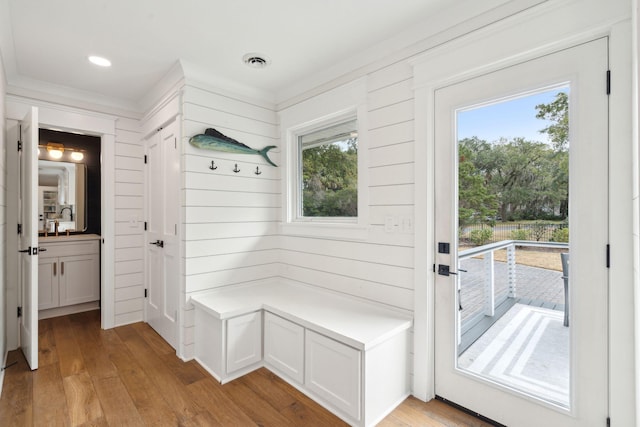 mudroom with wooden walls and light hardwood / wood-style floors