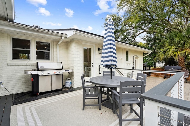 view of patio featuring a grill and a deck