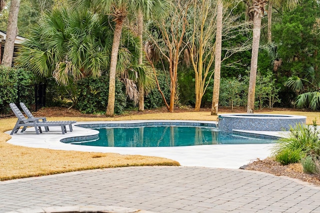 view of pool with a patio and an in ground hot tub