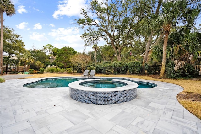 view of pool with an in ground hot tub and a patio area