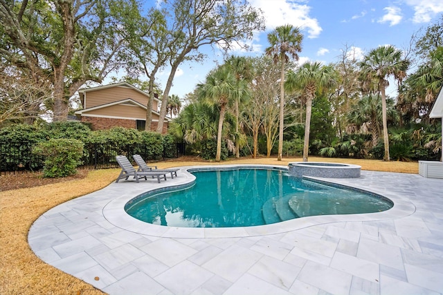 view of swimming pool featuring an in ground hot tub and a patio area