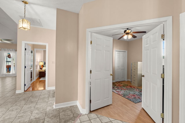 entrance foyer featuring a textured ceiling, light hardwood / wood-style flooring, and ceiling fan