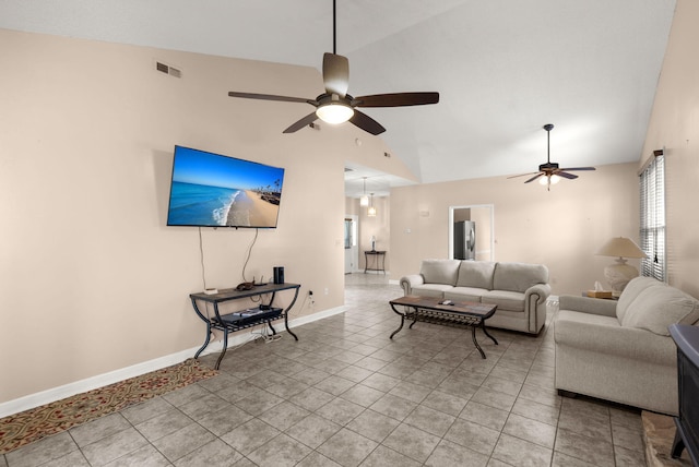 living room with ceiling fan, lofted ceiling, and light tile patterned floors