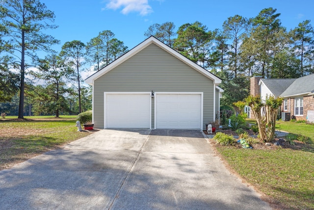 garage with a lawn and cooling unit