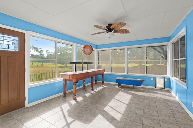 sunroom featuring plenty of natural light and ceiling fan