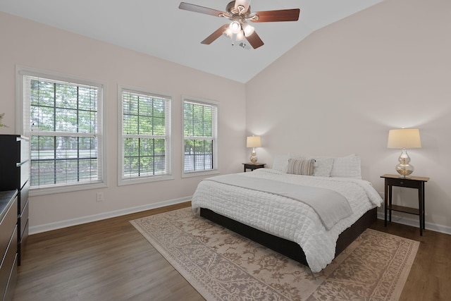 bedroom featuring a ceiling fan, baseboards, wood finished floors, and lofted ceiling