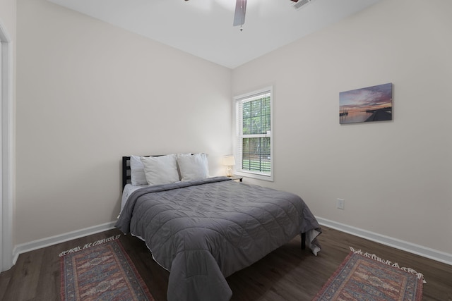 bedroom with a ceiling fan, baseboards, and wood finished floors