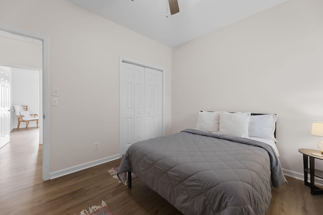 bedroom with baseboards, a ceiling fan, a closet, and wood finished floors