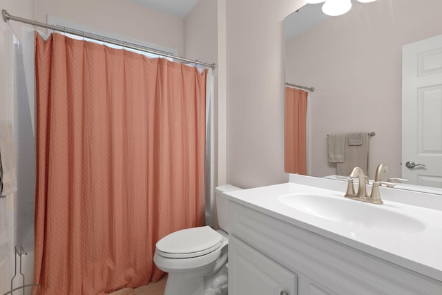 bathroom featuring toilet and vanity