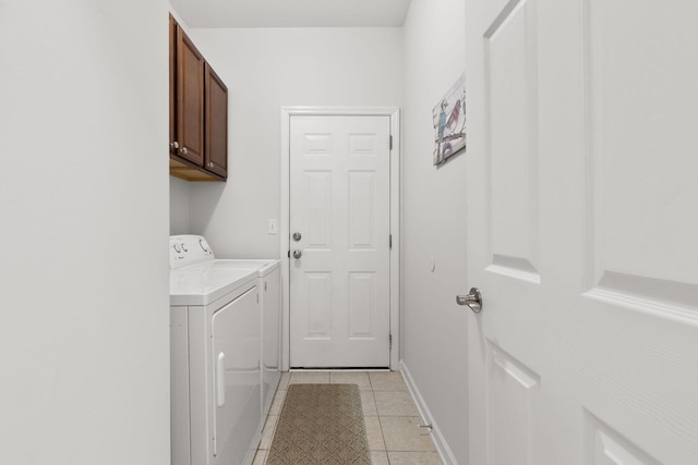 washroom featuring independent washer and dryer, baseboards, light tile patterned floors, and cabinet space