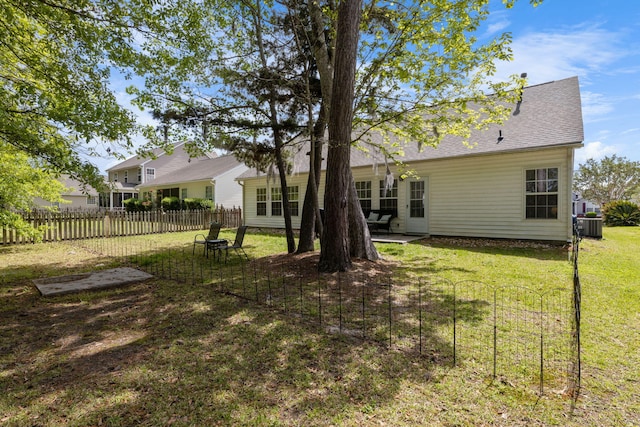 view of yard featuring central air condition unit and fence