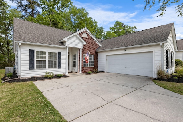 view of front of property featuring a front lawn, a shingled roof, central AC unit, concrete driveway, and an attached garage