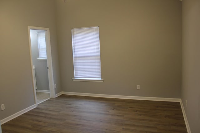 unfurnished room featuring dark hardwood / wood-style flooring