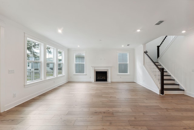 unfurnished living room featuring stairway, recessed lighting, light wood-style flooring, and visible vents