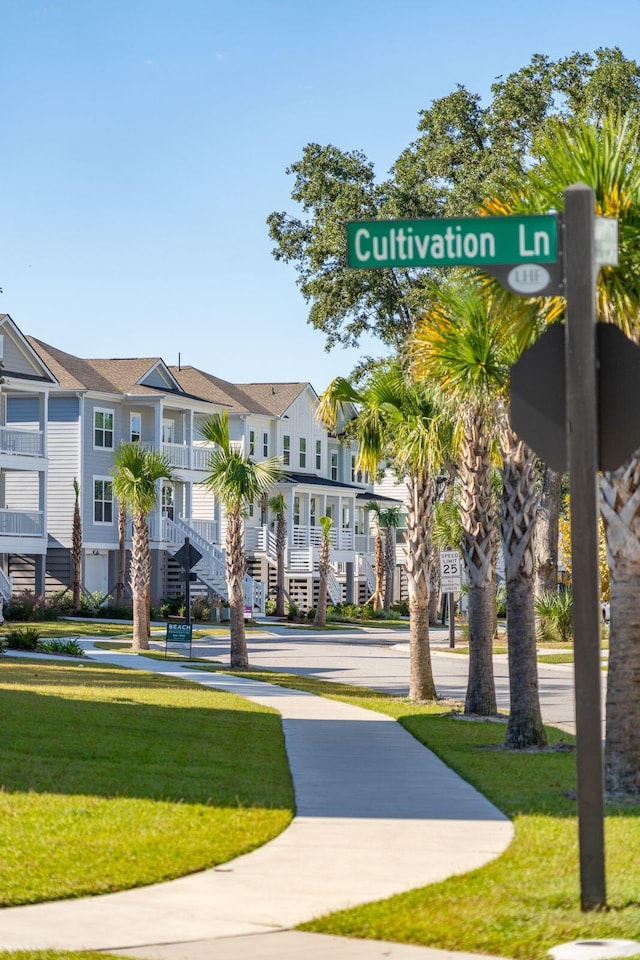 view of home's community featuring a residential view and a lawn