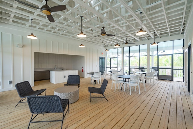 sunroom / solarium with a healthy amount of sunlight and ceiling fan