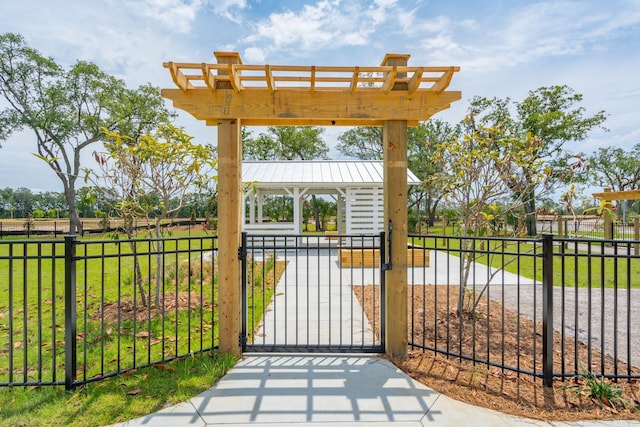 view of patio / terrace featuring a gate, fence, and a pergola