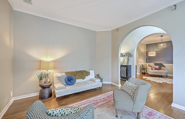 1972 Gray Battery Ct, Mount Pleasant, SC 29464 - living room with arched walkways, wood finished floors, ornamental molding, and a textured ceiling