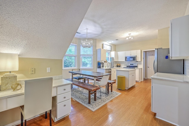 1972 Gray Battery Ct, Mount Pleasant, SC 29464 - kitchen featuring stainless steel appliances, a textured ceiling, light wood-style flooring, white cabinetry, and light countertops