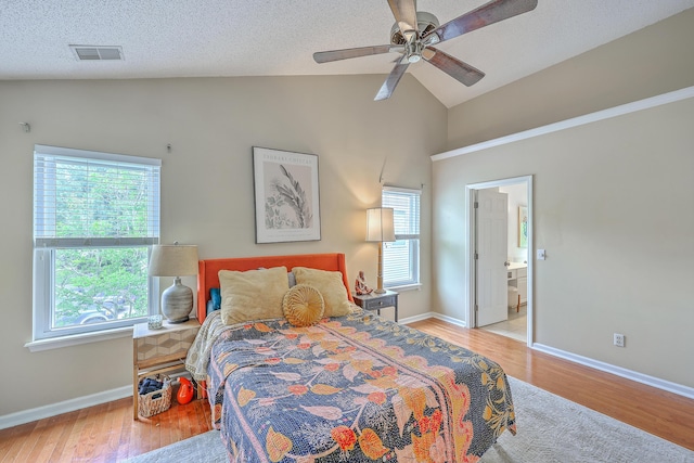 1972 Gray Battery Ct, Mount Pleasant, SC 29464 - bedroom featuring multiple windows, wood finished floors, connected bathroom, high vaulted ceiling, and a textured ceiling