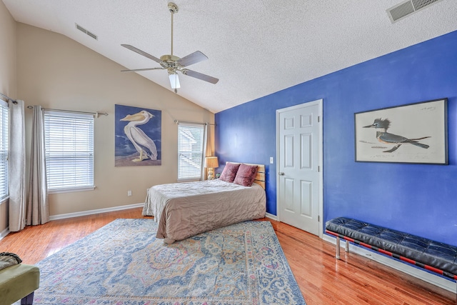 1972 Gray Battery Ct, Mount Pleasant, SC 29464 - bedroom featuring a textured ceiling, vaulted ceiling, multiple windows, wood finished floors, and a ceiling fan
