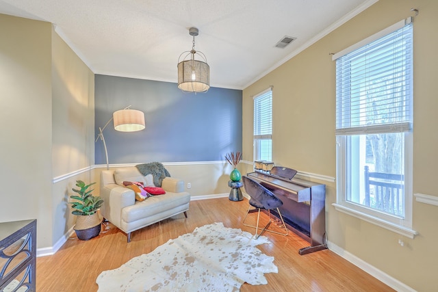 1972 Gray Battery Ct, Mount Pleasant, SC 29464 - living area featuring wood finished floors, ornamental molding, and healthy amount of natural light