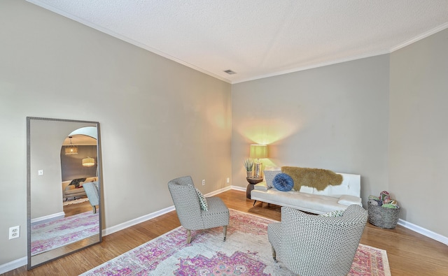 1972 Gray Battery Ct, Mount Pleasant, SC 29464 - sitting room featuring ornamental molding, wood finished floors, arched walkways, and a textured ceiling