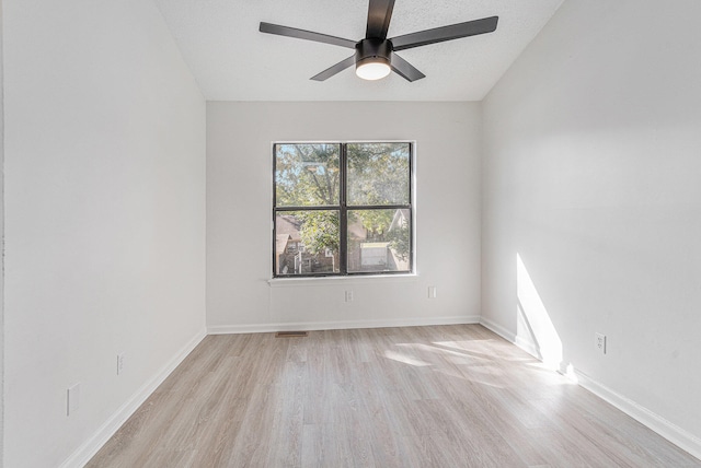 spare room with ceiling fan, light hardwood / wood-style flooring, and a textured ceiling