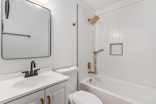 full bathroom featuring a textured ceiling, vanity, toilet, and tiled shower / bath