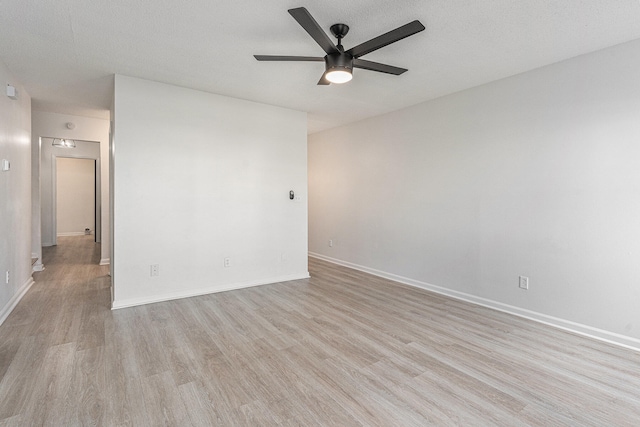 unfurnished room with ceiling fan, light hardwood / wood-style floors, and a textured ceiling