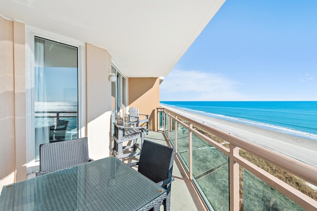 balcony featuring a water view and a view of the beach