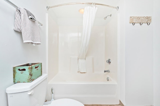 bathroom featuring toilet and shower / tub combo with curtain