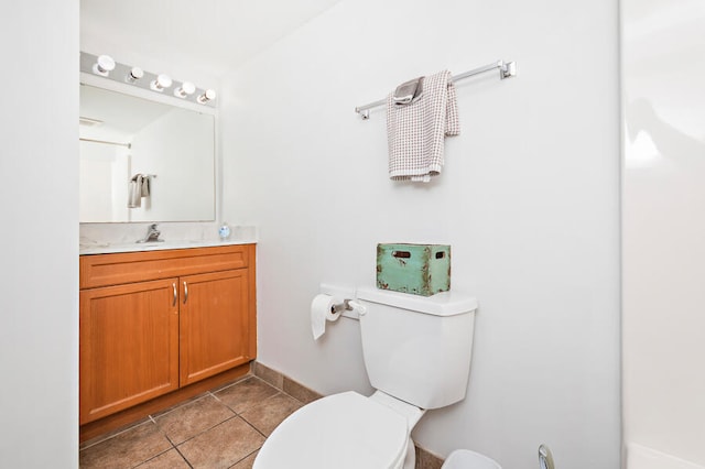 bathroom with tile patterned floors, vanity, and toilet