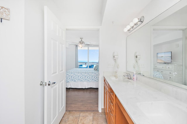 bathroom with tile patterned flooring, vanity, and ceiling fan