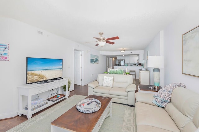 living room with ceiling fan and light hardwood / wood-style flooring