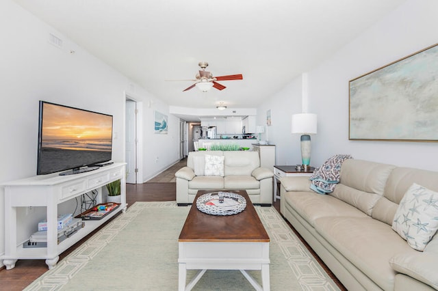 living room with hardwood / wood-style floors and ceiling fan