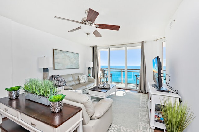 living room with ceiling fan and expansive windows