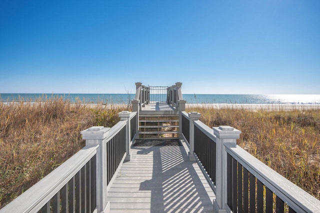 view of home's community with a water view and a view of the beach