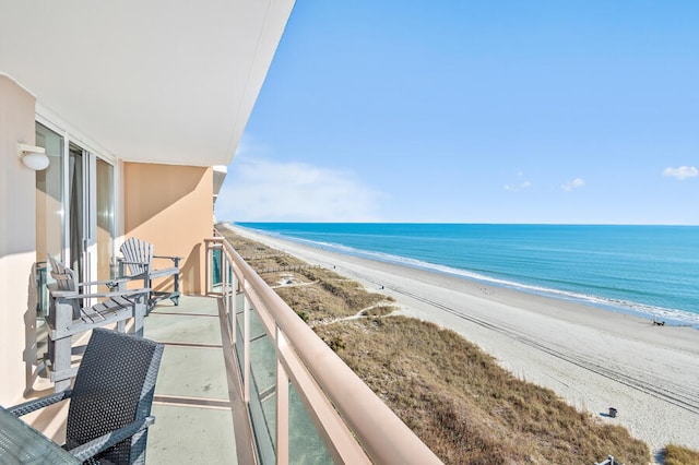 balcony with a water view and a beach view