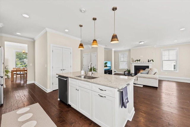 kitchen featuring a sink, dishwasher, healthy amount of natural light, ornamental molding, and light stone countertops