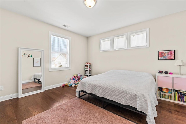bedroom featuring wood finished floors and baseboards