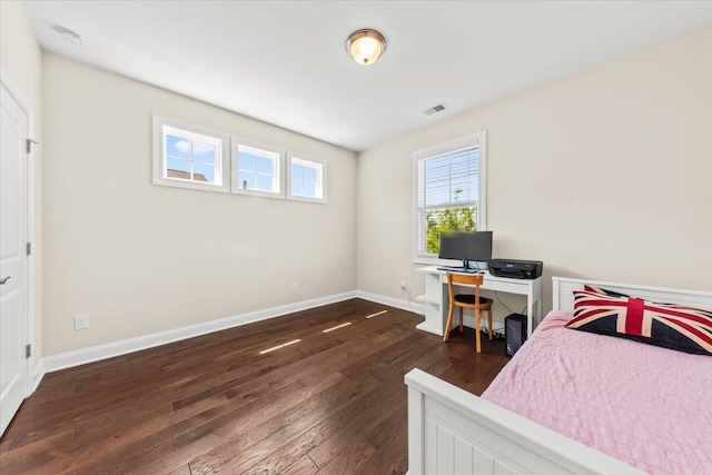 bedroom featuring dark wood-style flooring and baseboards