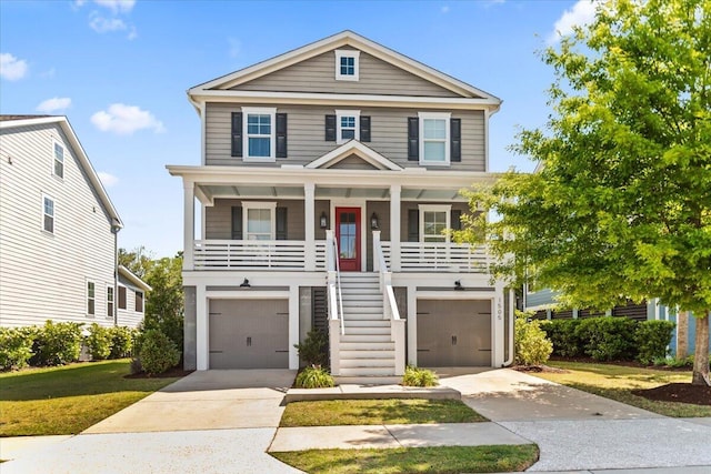 coastal inspired home with stairs, covered porch, driveway, and an attached garage