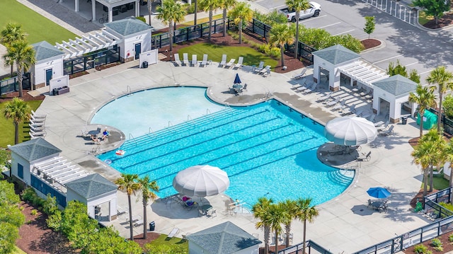 community pool featuring fence, a pergola, a patio, and a gazebo