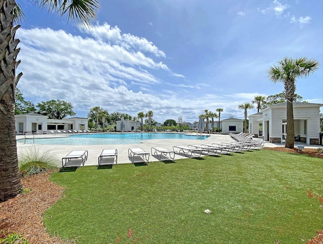 community pool with a lawn and a patio area