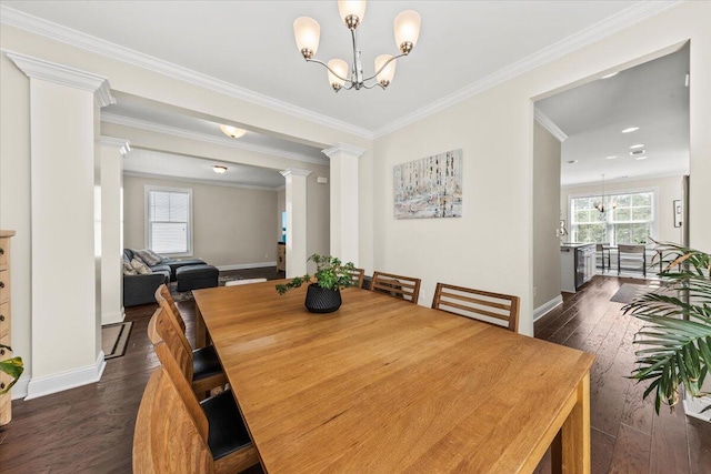dining area featuring a chandelier, dark wood-style flooring, decorative columns, ornamental molding, and baseboards
