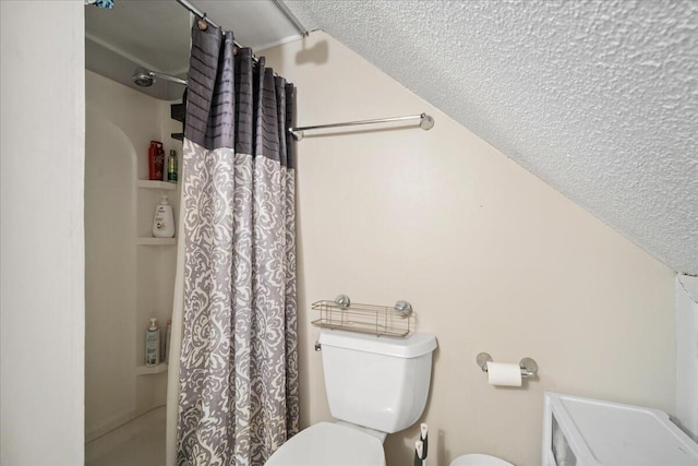 bathroom with toilet and a shower with shower curtain
