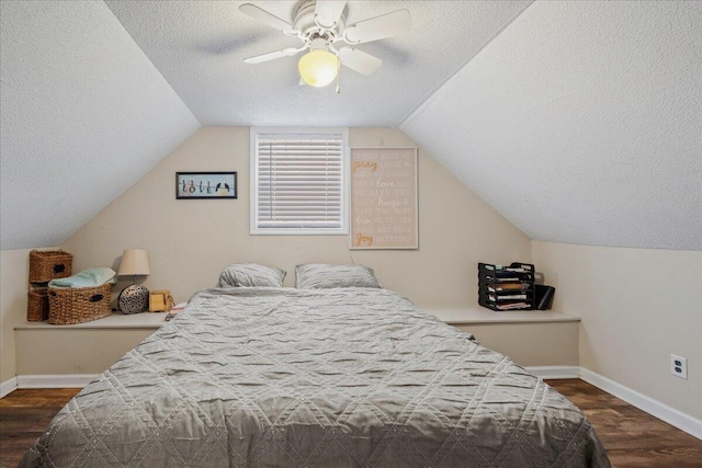 bedroom with lofted ceiling, a ceiling fan, a textured ceiling, dark wood finished floors, and baseboards